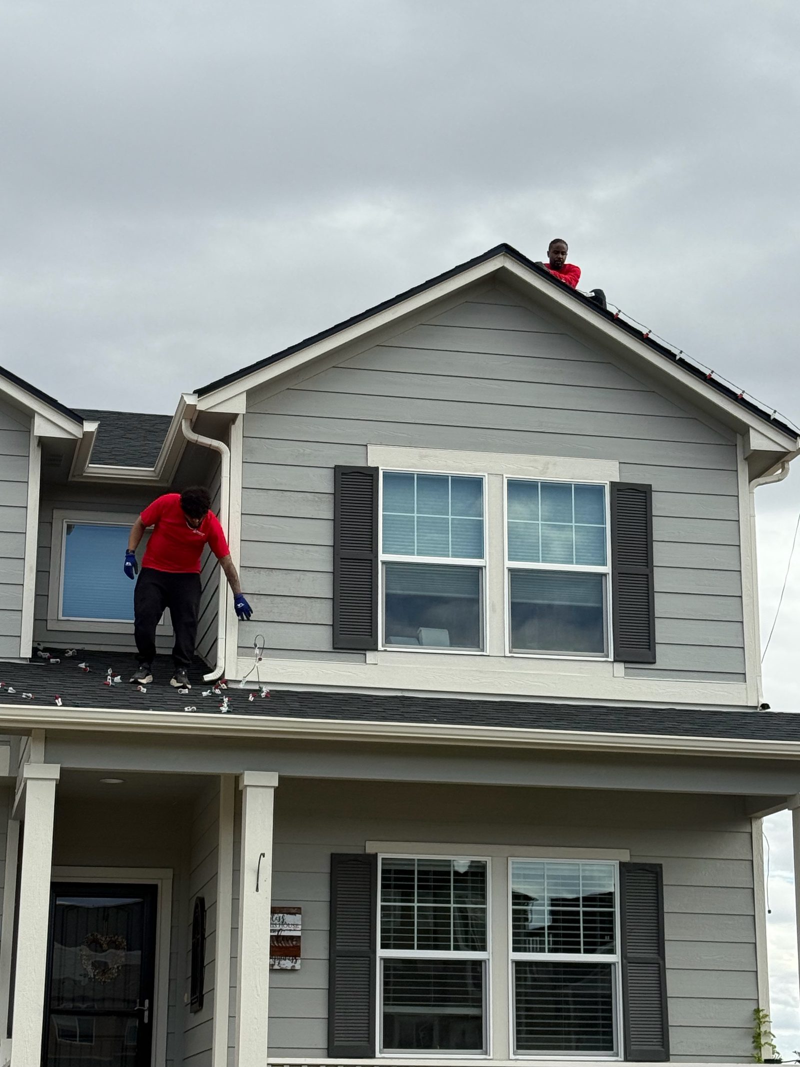 Professional Christmas light installation crew on roof installing LED lights in Front Range Professional Christmas light installation crew on roof installing LED lights in Front Range